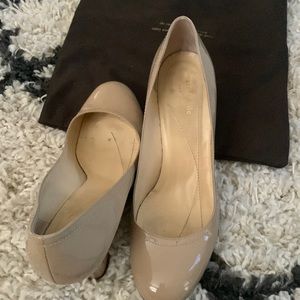 A pair of kate spade wedge shoes